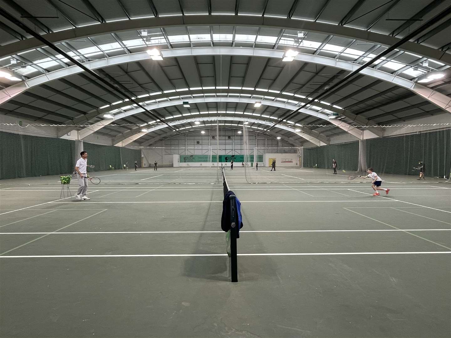Tim Henman giving a tennis lesson to nine-year-old Sam Dennison at Deal Indoor Tennis Centre