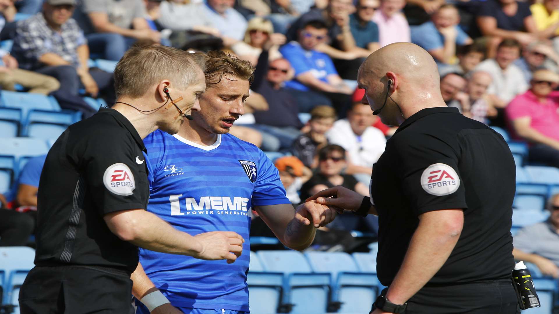 Gillingham midfielder Lee Martin gives a coin to referee Charles Breakspear back in April Picture: Andy Jones