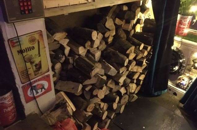 A well-stocked log store takes advantage of space under the dartboard