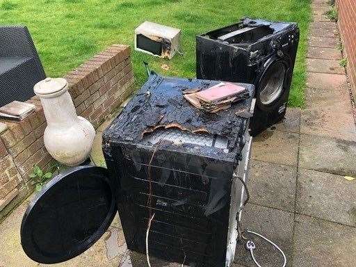 Crews removed the washing machine and tumble dryer to the garden. Picture: Kent Fire and Rescue Service