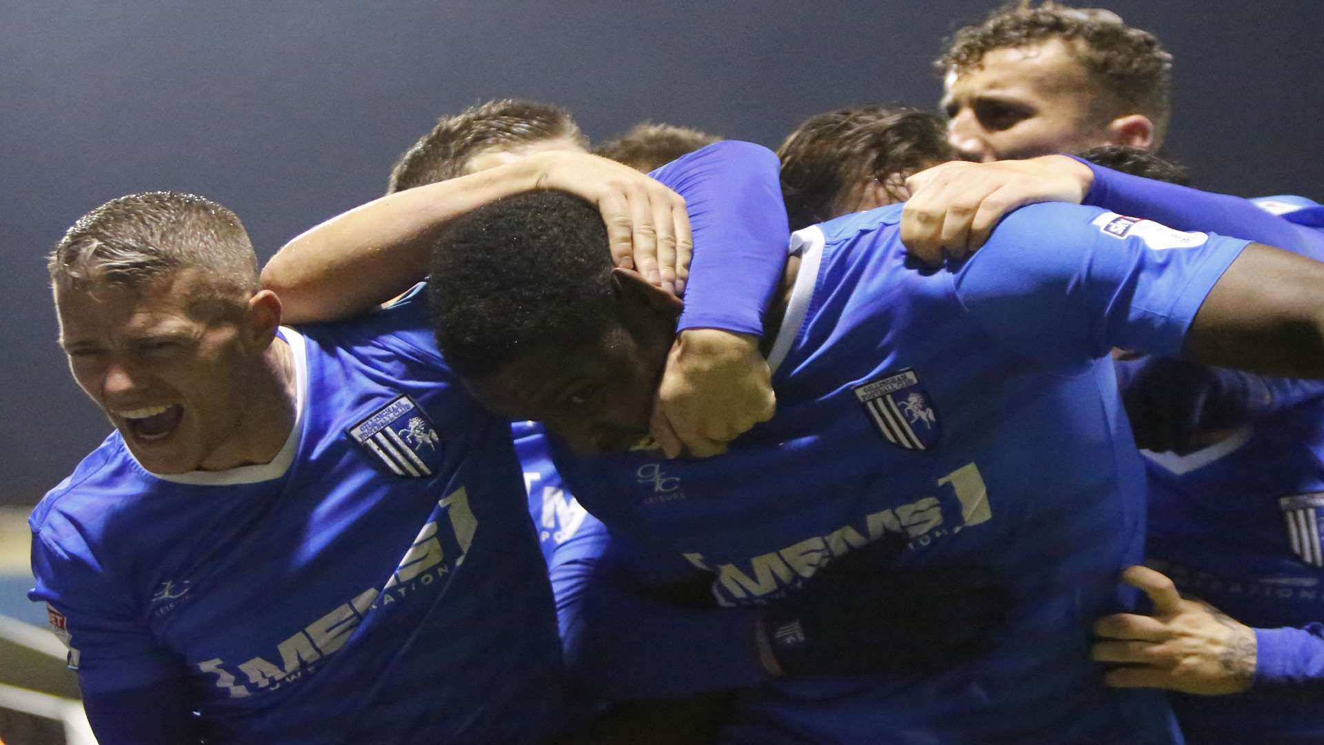 ...and is mobbed by relieved team-mates as Gills regain the winning feeling in League 1 at last Picture: Andy Jones