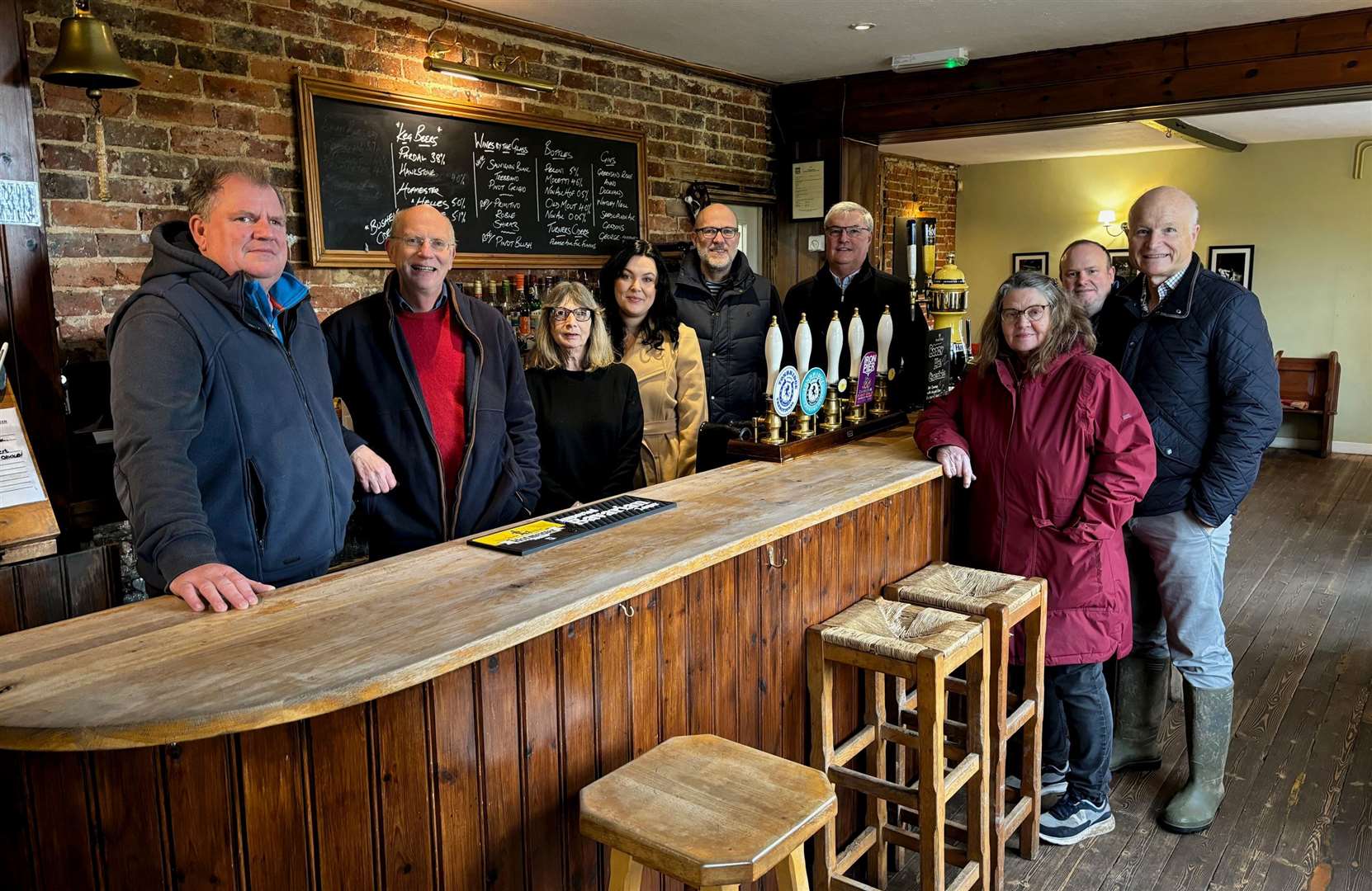 The steering committee: behind the bar, from left, Warren Gilbert, Jonathan Pearce, Kim Mitchell, Kerry Goodfellow, Graham Bonner-Leney and Alan Ritchie. In front of the bar, from left, Sarah Talbutt, Robert Merrifield and Michael Wooldridge