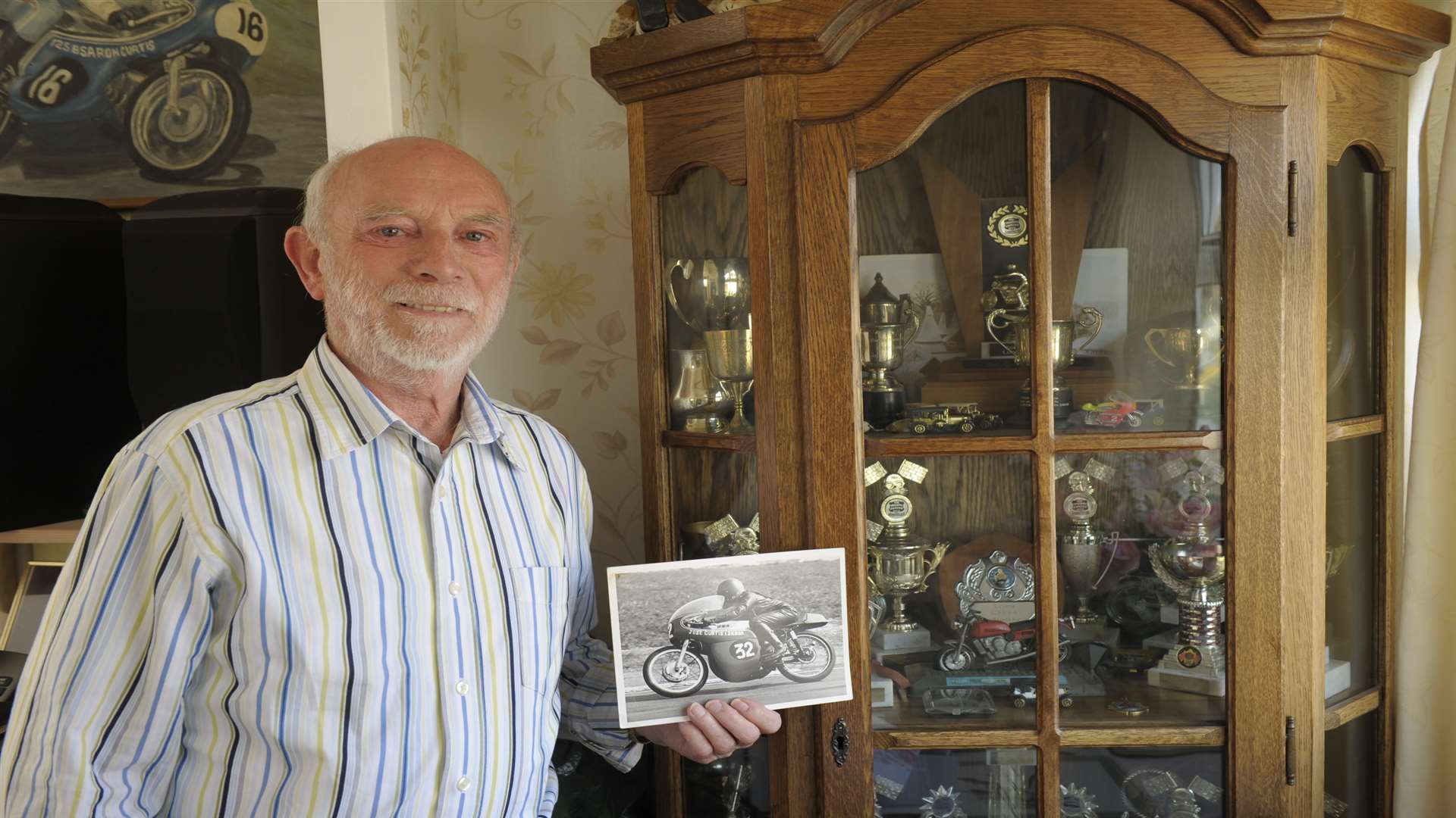 Ron Curtis with the cabinet containing all of Jose's motorcycling trophies. Picture: Steve Crispe.