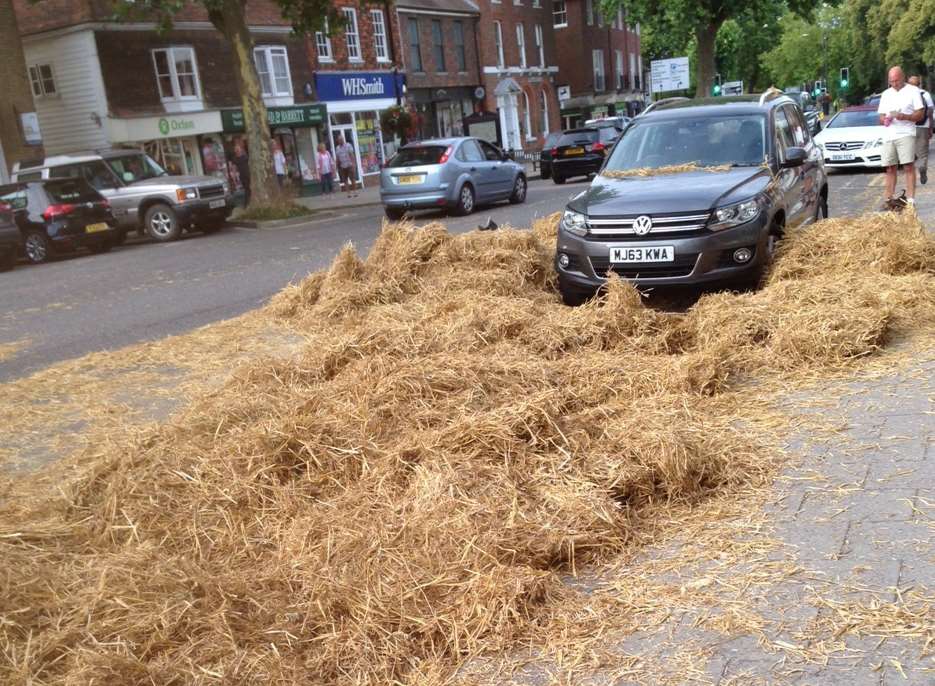 Straw is strewn over the road after the accident