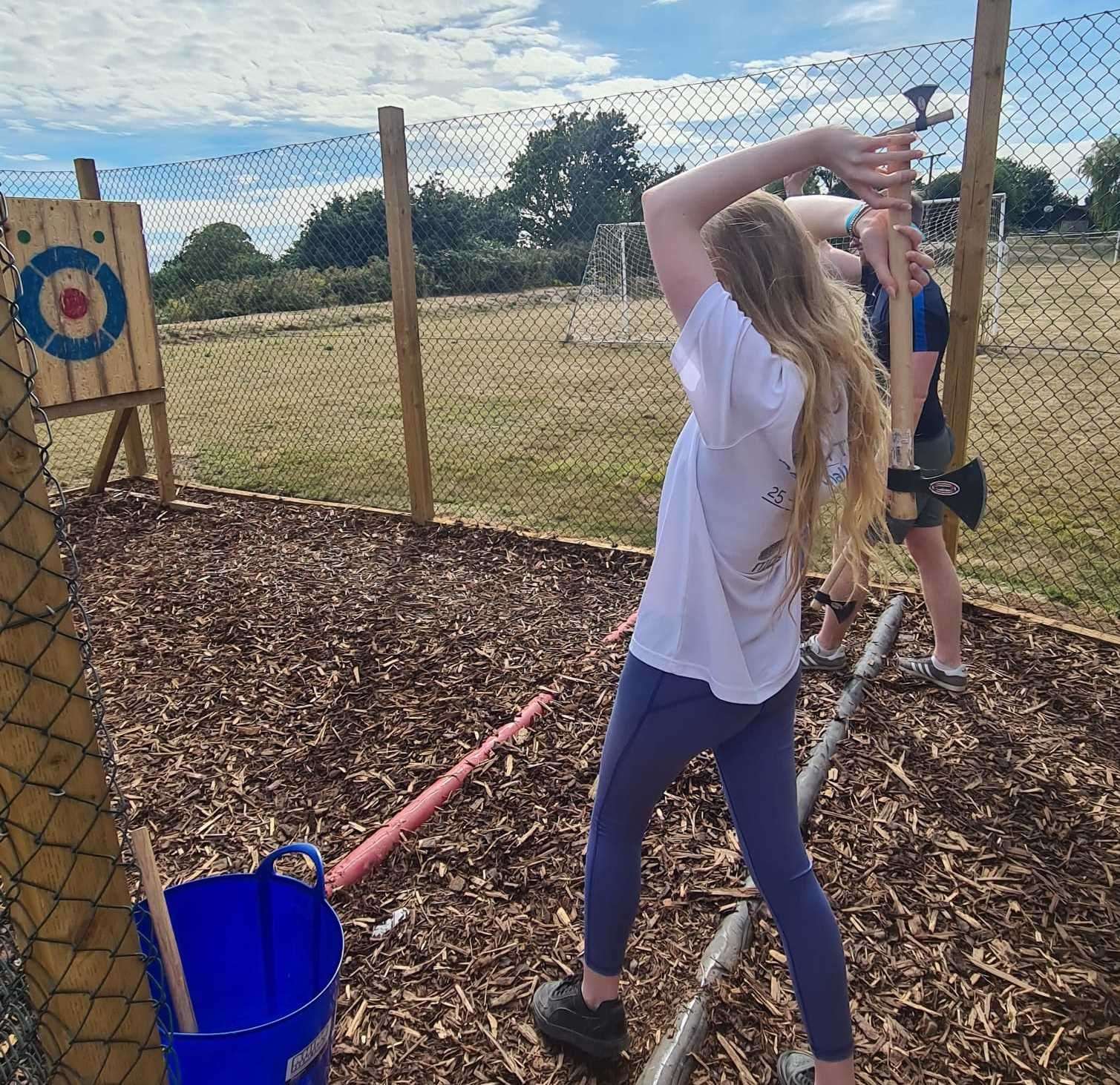 My daughter taking aim during axe-throwing