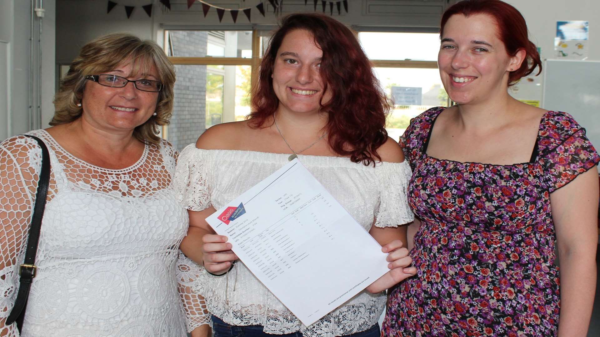 Georgie Sherriff flanked by her proud mum Kim, (left) and maths teacher Elizabeth Panayiotou