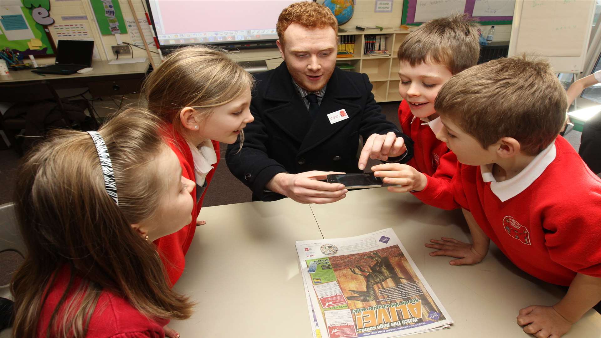 Pupils at Langafel Primary School watch reporter Ben Kennedy use the app