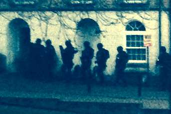 Armed officers outside the house