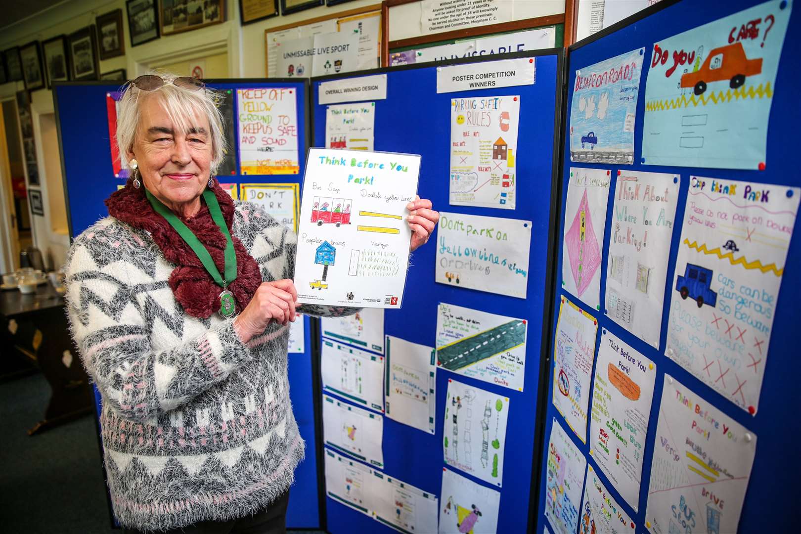 Chairman of Meopham Parish Council Sheila Buchanan with the winning poster design for the parking safety campaign and others from Meopham school children.