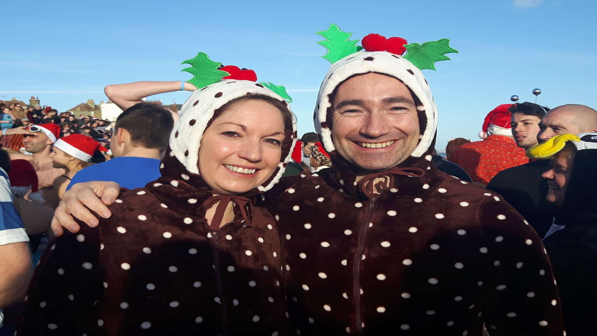 Sister and brother Sarah and Peter Baldwin dressed in Christmas pudding onesies