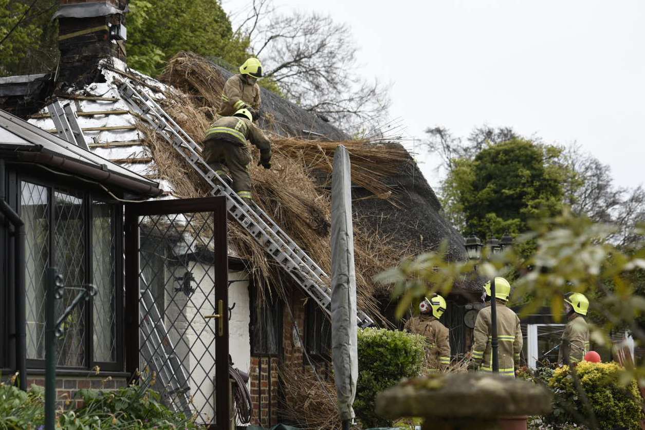 Firefighters clear up after the cottage blaze, Leaveland. Picture: Alan Langley