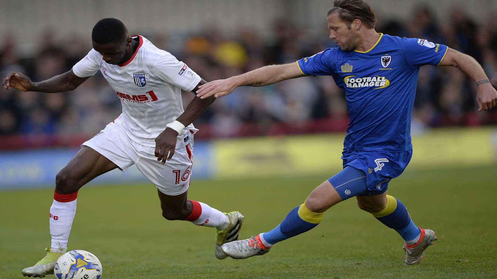 Emmanuel Osadebe chased by AFC Wimbledon's Dannie Bulman Picture: Ady Kerry