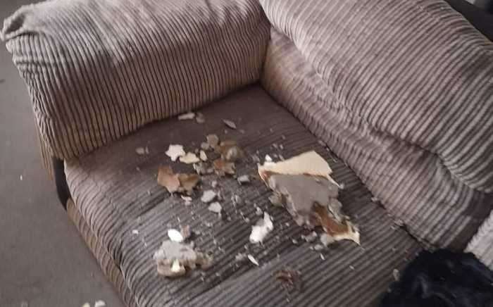 Ceiling in the front room falling onto the family furniture. Picture: Luke Hutson