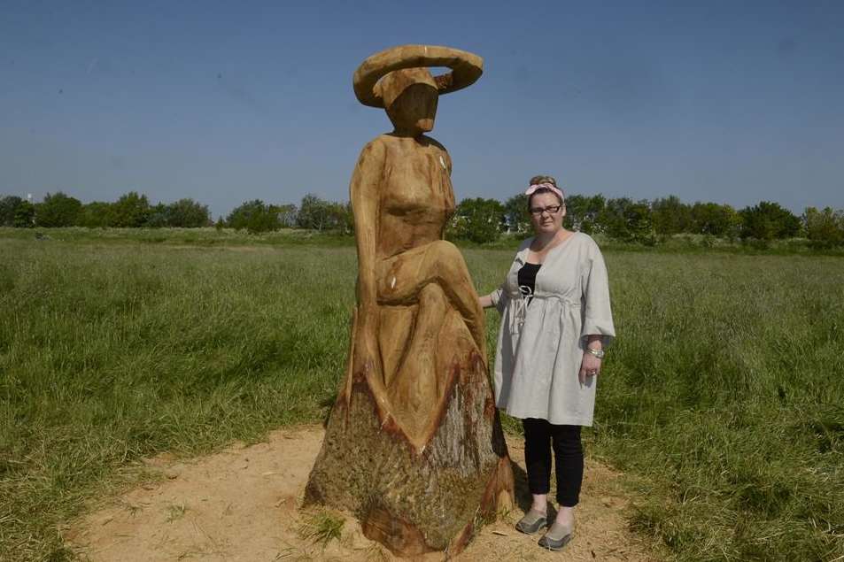 Mandy Shade with the woman sitting chainsaw sculpture at Barton's Point coastal park