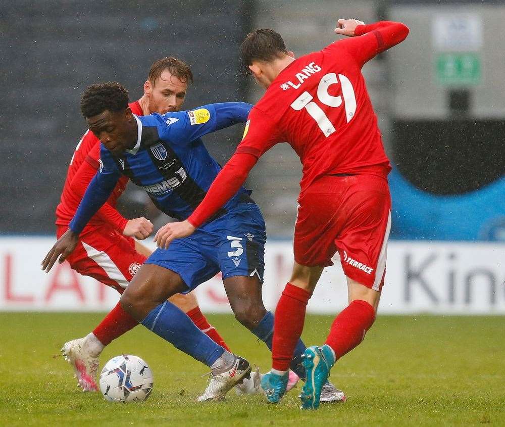 Gillingham defender David Tutonda in the thick of the action against Wigan. Picture: Andy Jones