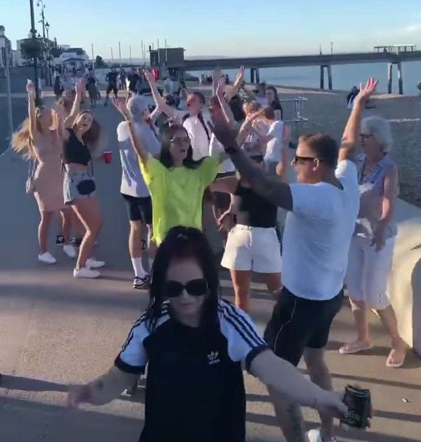 Beach goers dance to the YMCA Picture: @DiscoBoyuk