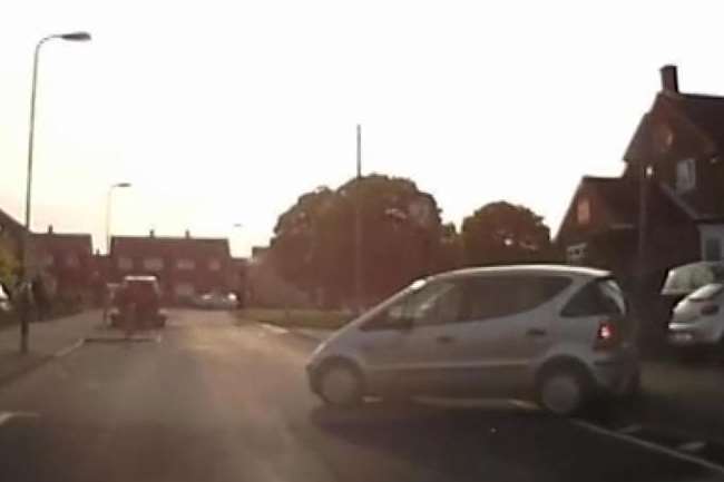 This driver executed a three-point turn, blindly reversing into a signpost