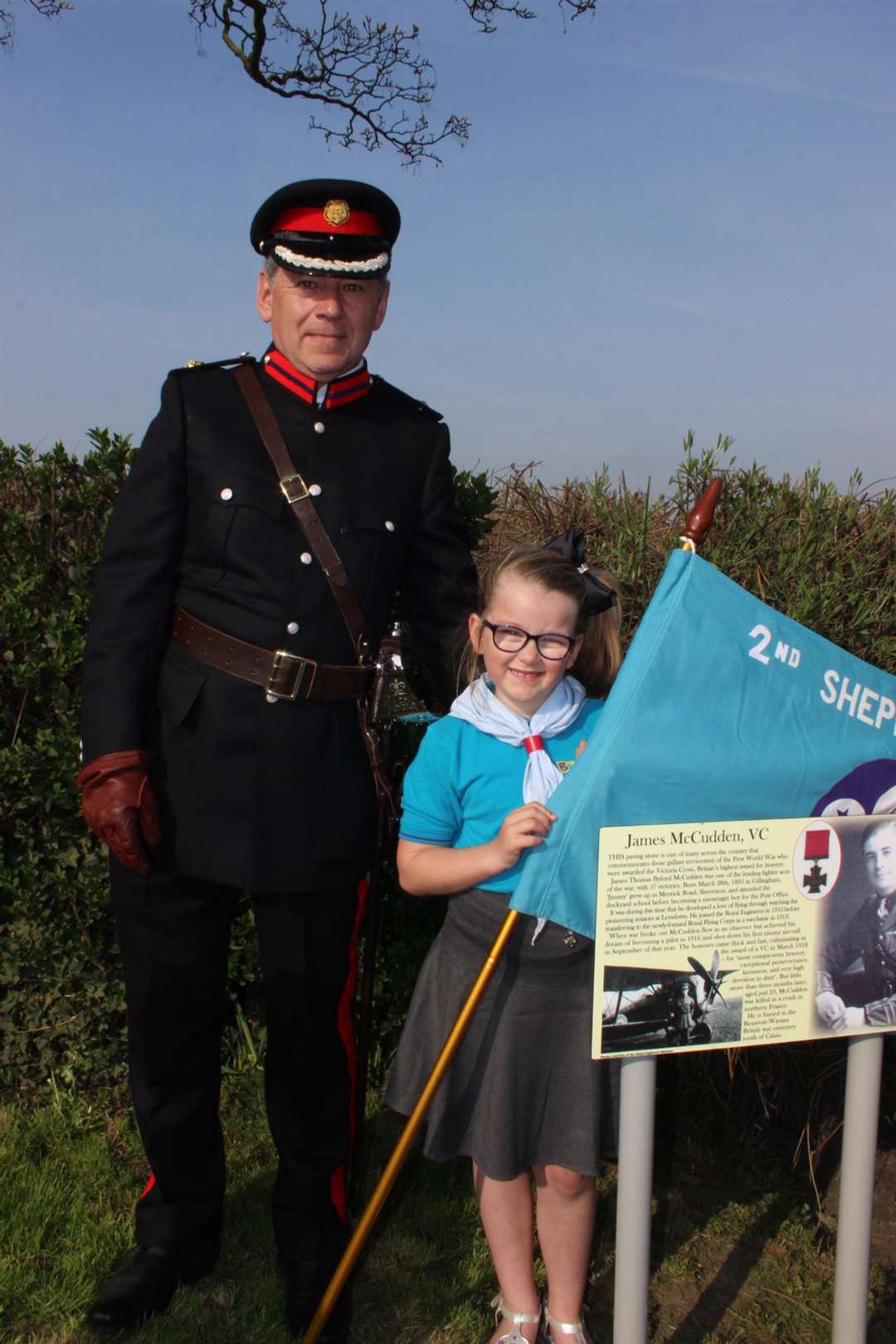 Deputy Lord Lieutenant of Kent Paul Auston with Cassy Taylor, seven, from Queenborough at the unveiling of the Capt James McCudden VC paving stone at Sheerness War Memorial
