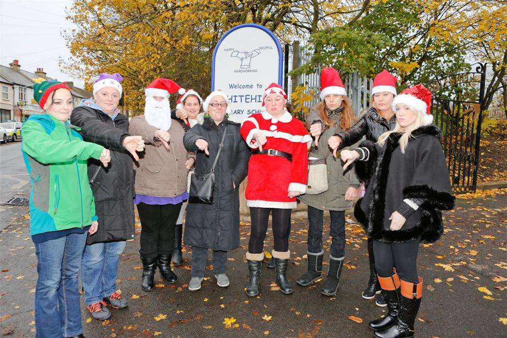 Parents protest outside Whitehill Primary School at the head teacher's policy of no Christmas before December.