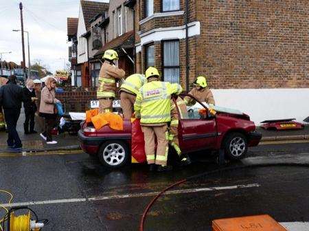 Firemen work to free a woman in St Helen's Road, Sheerness, following an accident