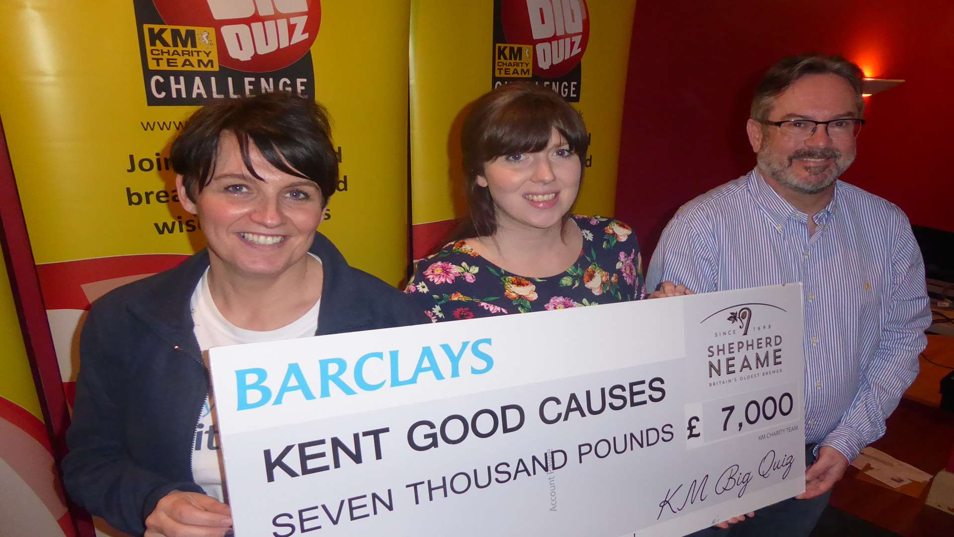 Donna Newland of Barclays joins Jenni Horn of the Medway Messenger and David Moorman of Specsavers to announce the amount raised for charity at the Medway heat of the KM Big Charity Quiz.