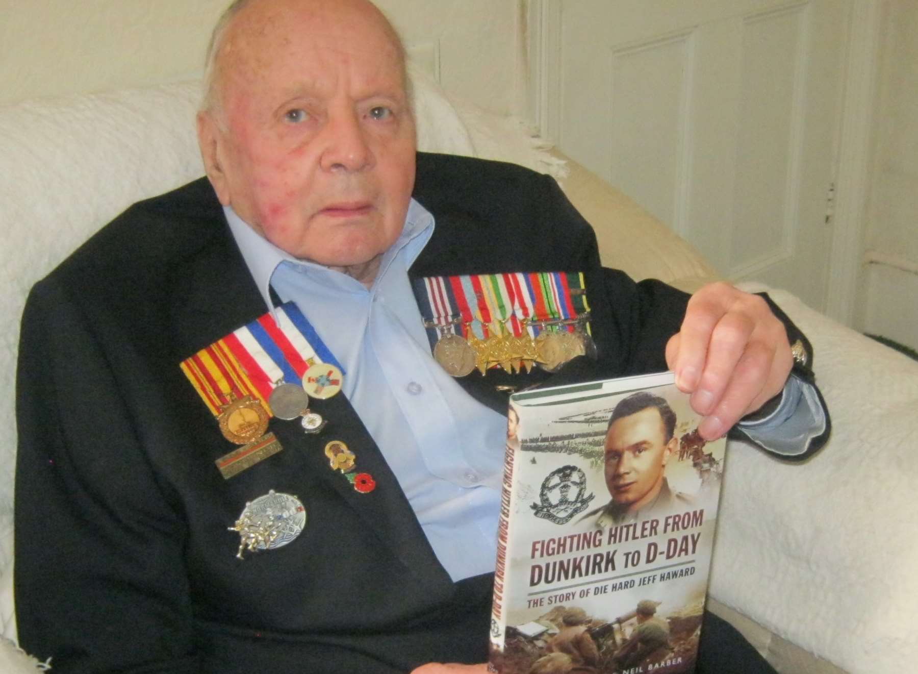 Jeff Haward with the book he has written of his wartime experiences.