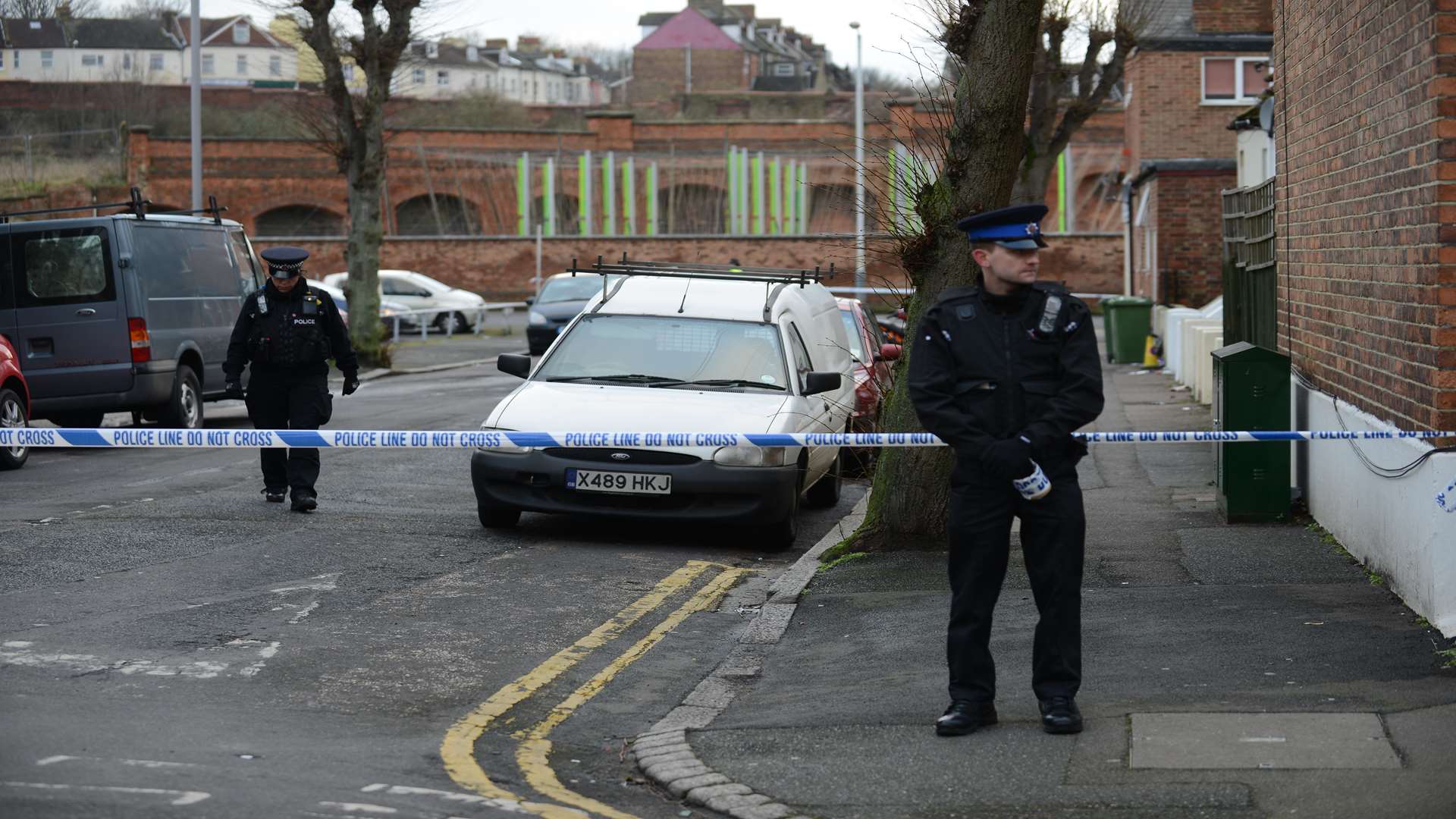 Officers standing guard at the scene this afternoon. Picture: Gary Browne