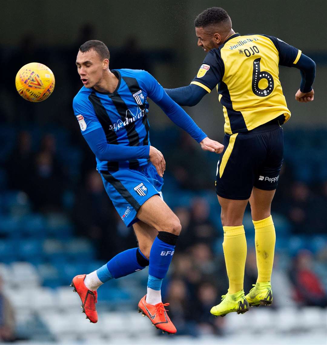 Gills' Graham Burke jumps for the ball with Funso Ojo Picture: Ady Kerry