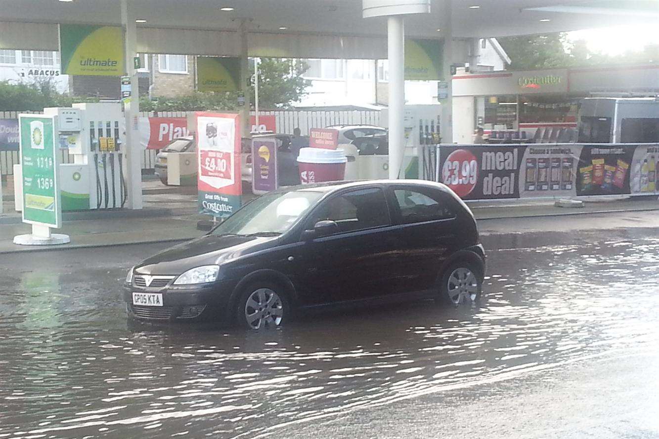A car stranded in floodwater outside the BP garage in New Romney High Street.