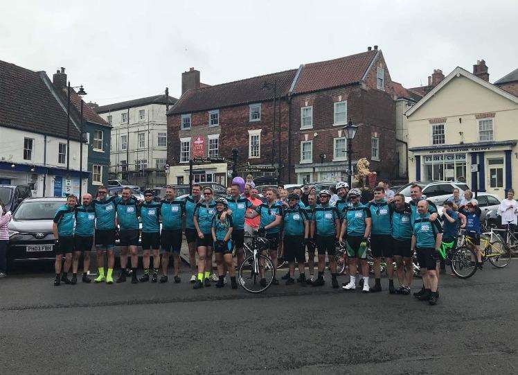 The group posed for a picture after they completed the ride on Saturday. (2347334)