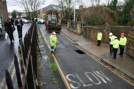 Engineers from Southern Water fix a burst water main in Hill's Terrace, Chatham