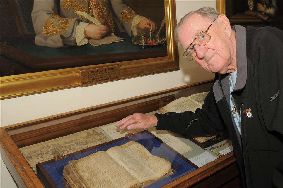 Nigel Marchment looks at a bible that was baked in bread to hide it