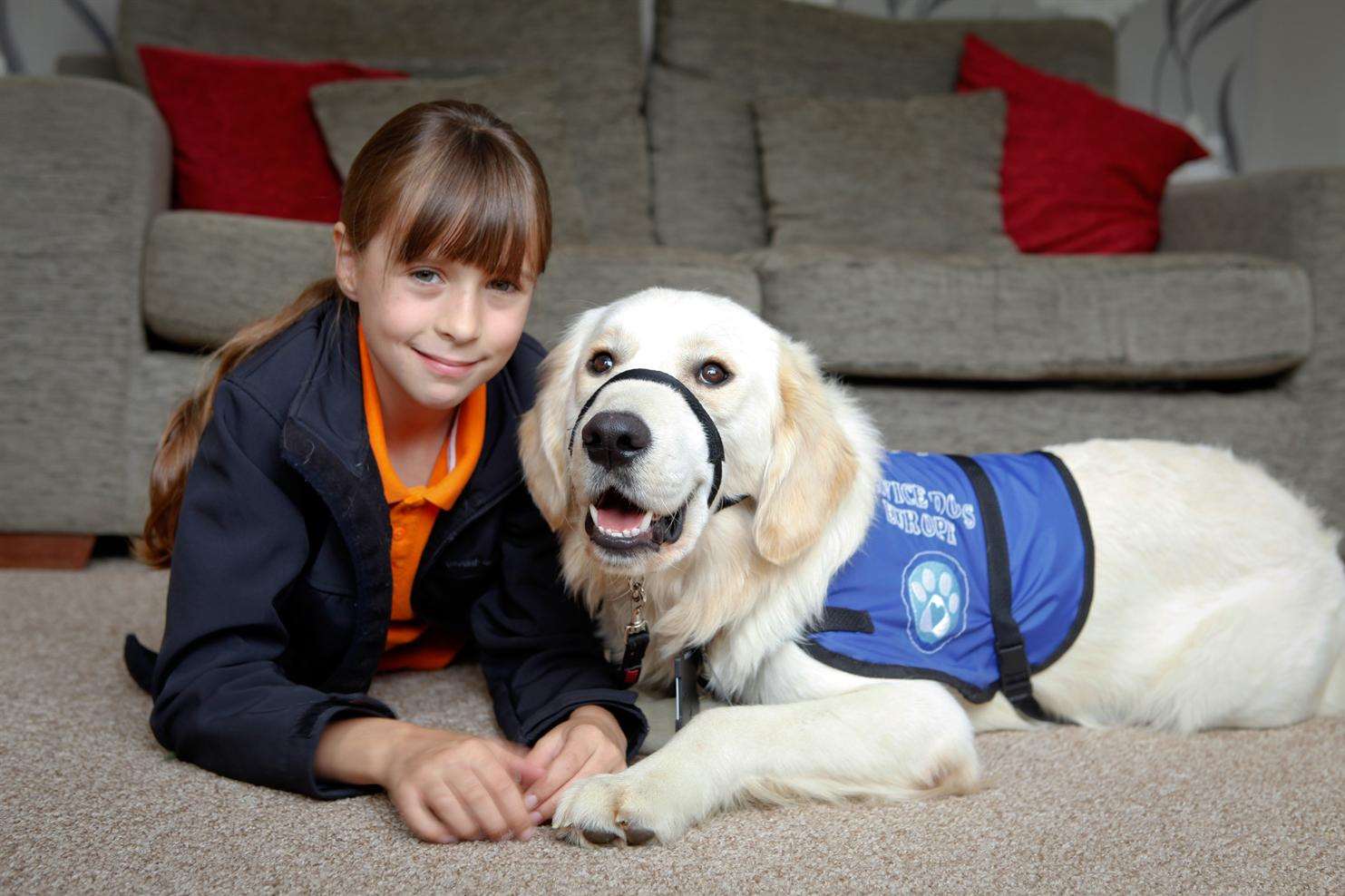 Amy Baker, 11, with psychiatric service dog Buddy