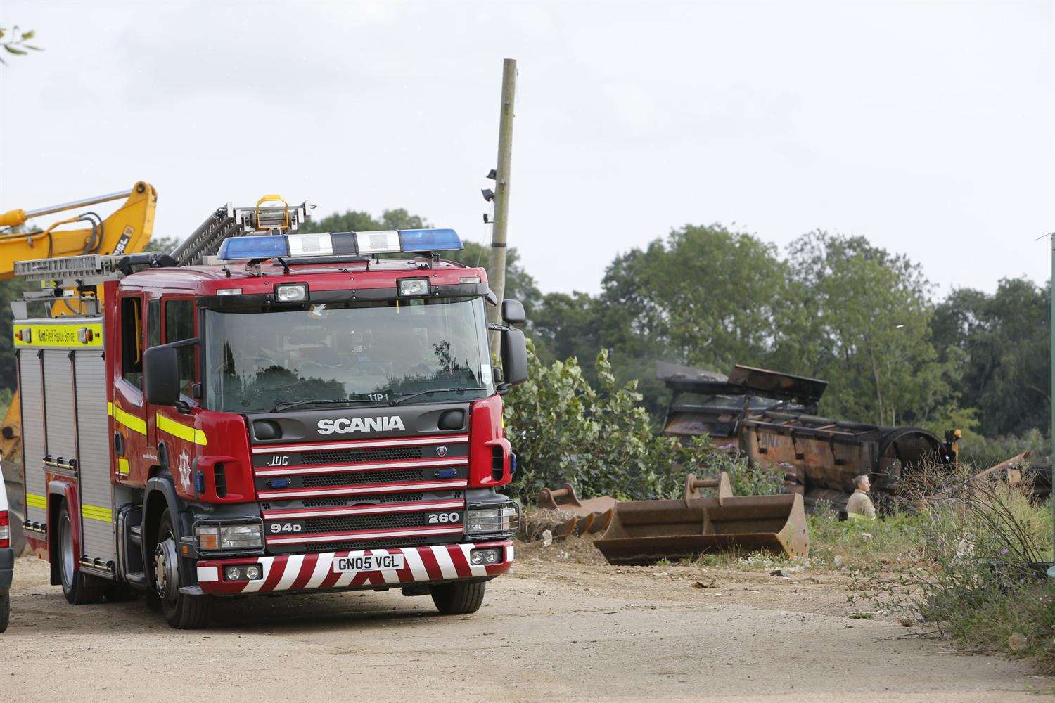 Firefighters damp down after a blaze at a landfill site in Tovil