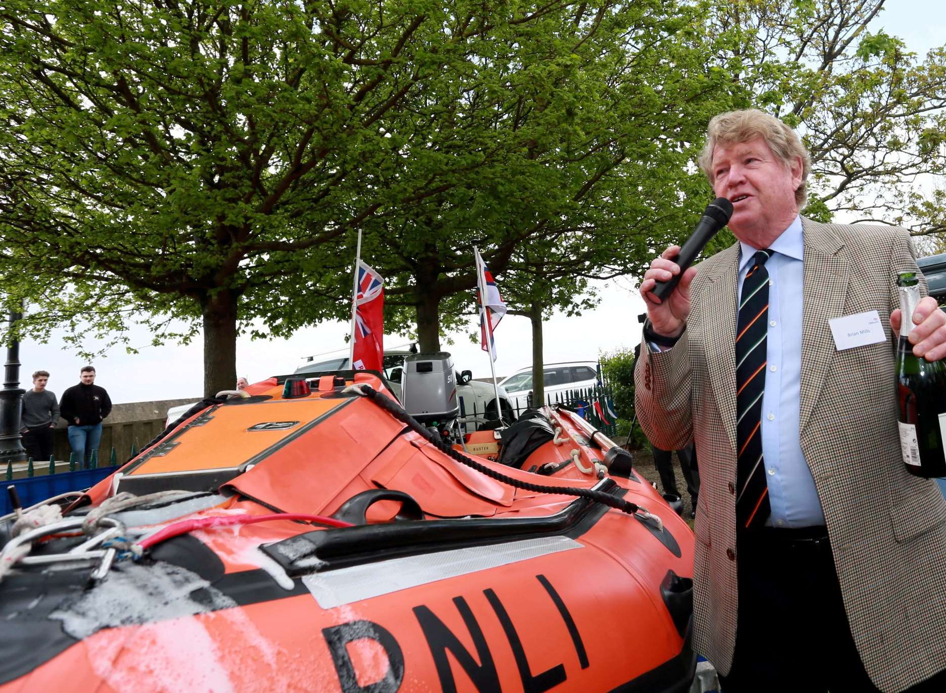 Brian Mills officially names the new lifeboat in the traditional way with champagne