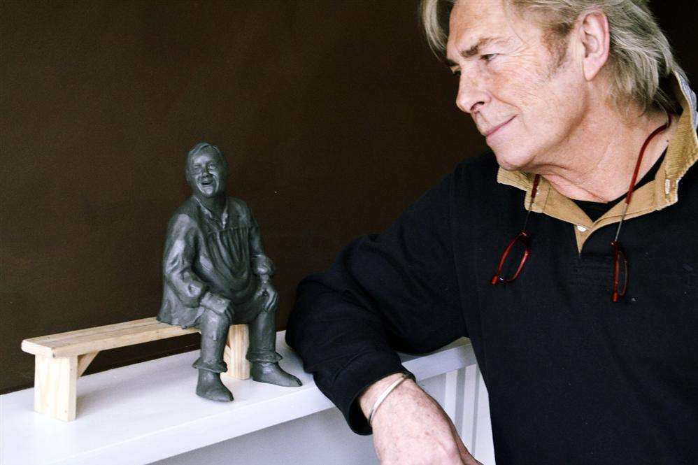 Sculptor Dominic Grant with the miniature of Dave Lee and the bench