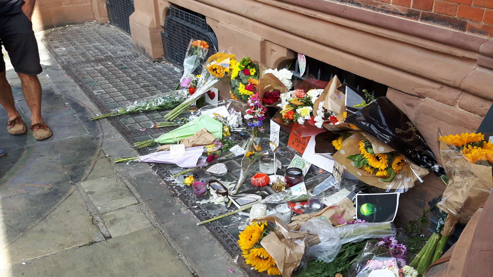 Floral tributes to Maximum Martin, James Truscott and Joshua Lambert-Price outside the Beaney