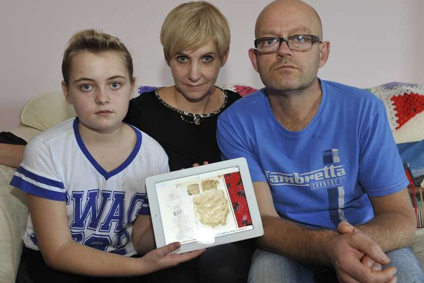 Maddie, Sam and Colin Marsh with a replacement iPad showing the slab of clay they got from Tesco