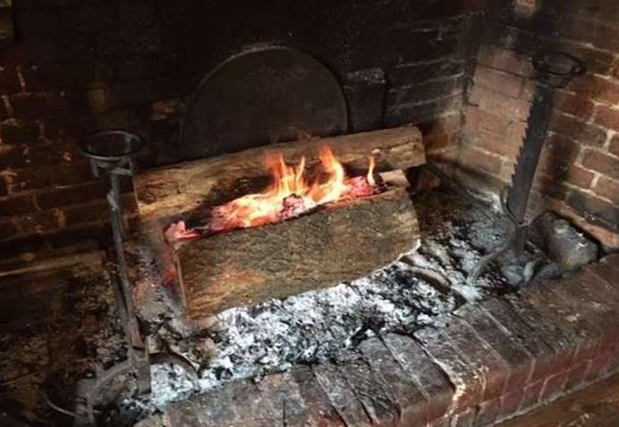 A large inglenook fireplace, regularly replenished with fantastically seasoned logs, is right at the heart of the Cock Inn pub
