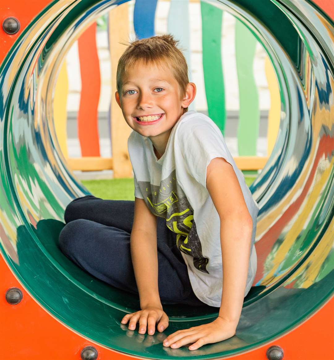 The play area includes climbing frames, a slide and interactive elements.