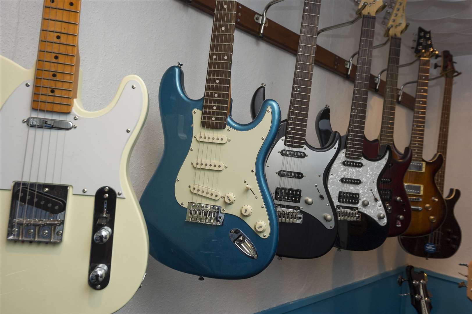 A line of guitars hang up in Elephant Music, Gravesend