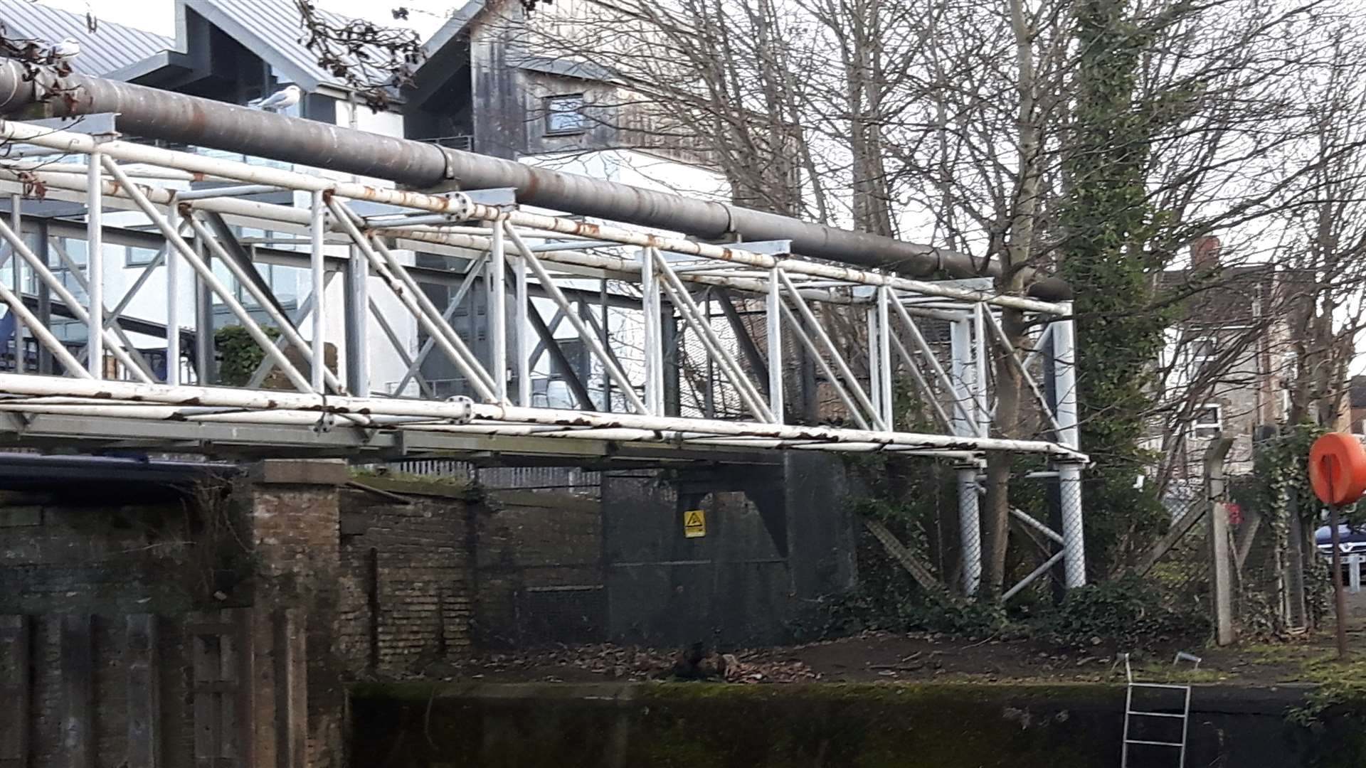 Today, the view of the footbridge over the river is obscured by a secondary utility bridge when seen from upriver on the Fant side