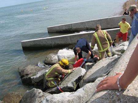 Rescuers free woman with head trapped as tide comes in