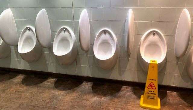 It wouldn’t be a bank of urinals in a Wetherspoon pub if there wasn’t a yellow warning sign