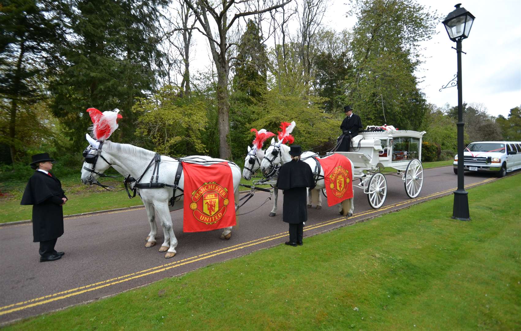 A horse-drawn carriage and Manchester United flags featured at the funeral. Picture: Steve Salter