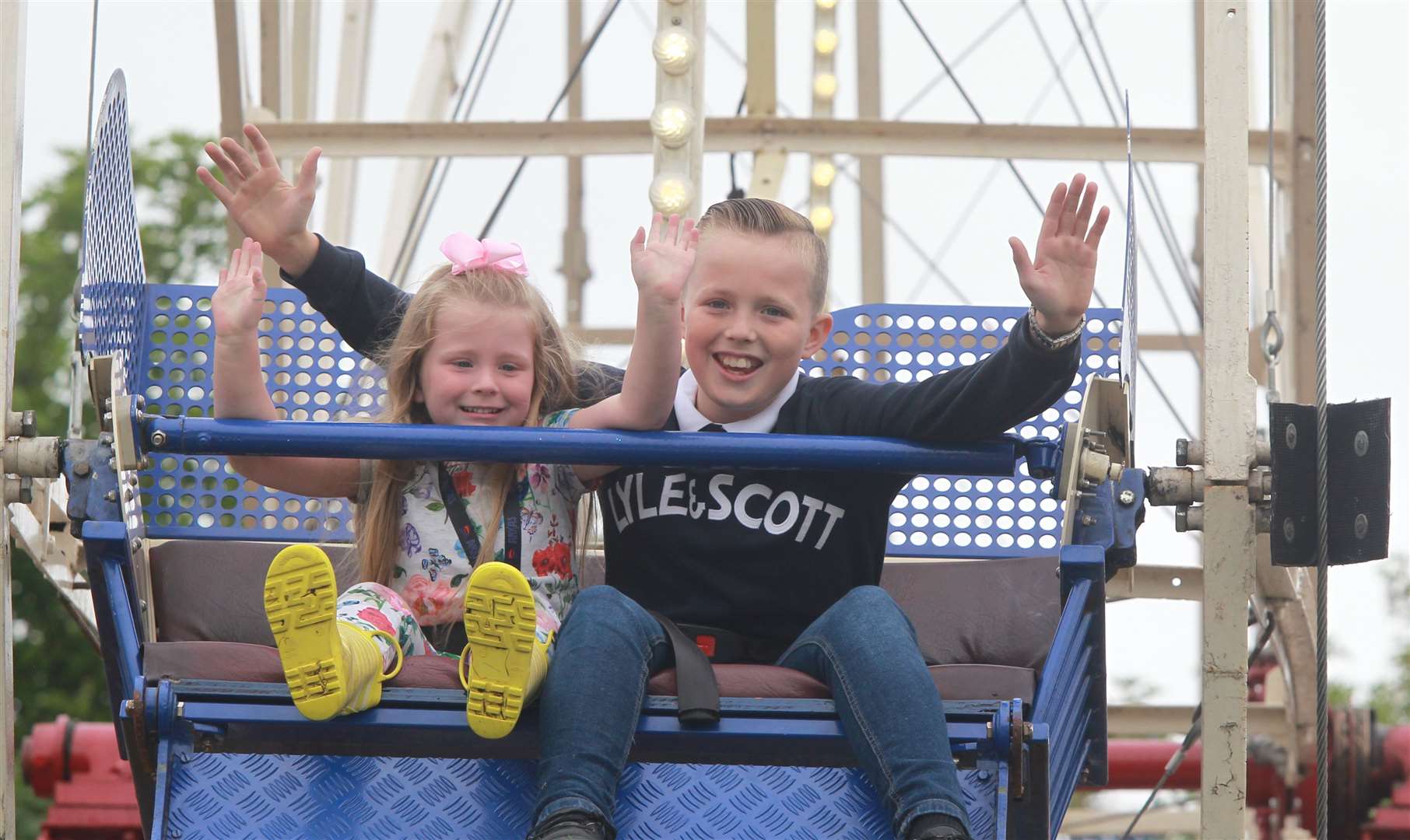 Grace Brooker, four with her brother, Lee, 12 on the big wheel at the Kent County Show Picture: John Westhrop