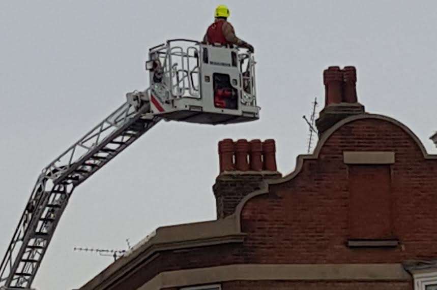 A firefighter was attempting to reach the man using a turntable ladder