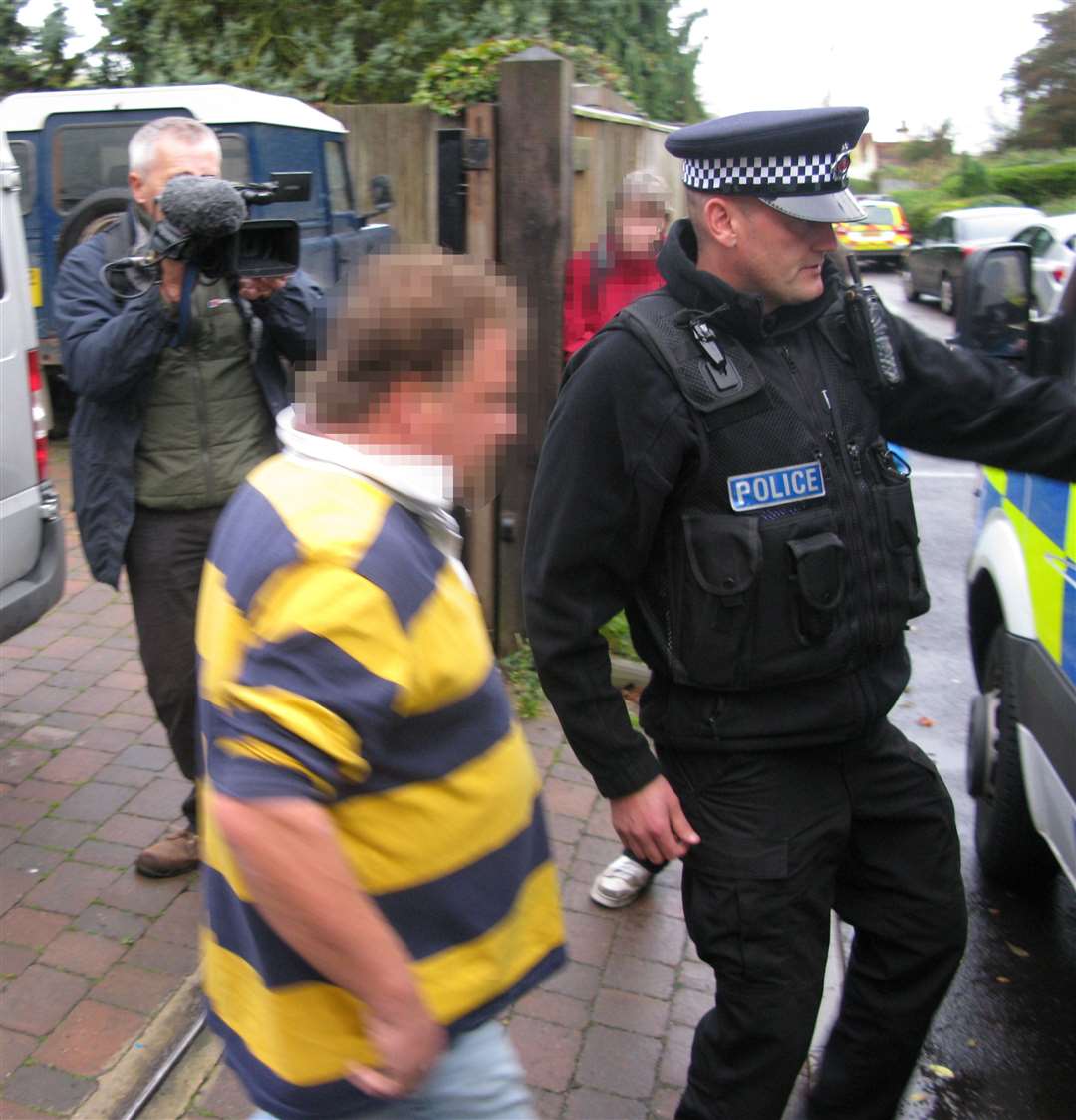 Darrell Houghton being arrested by police during the raid in 2012. No criminal charges were brought in England