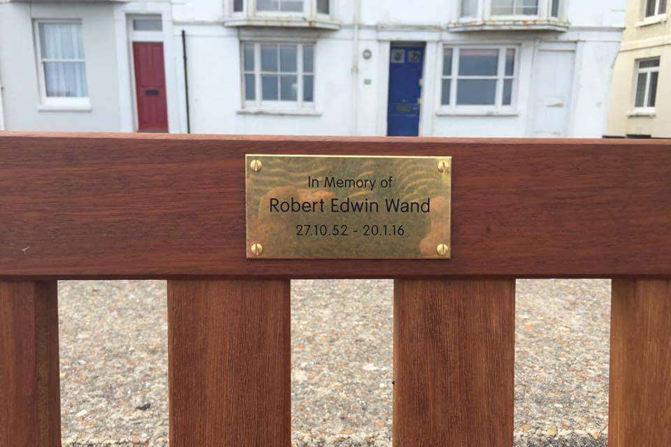 The dedication to Robert Wand on the back of the bench