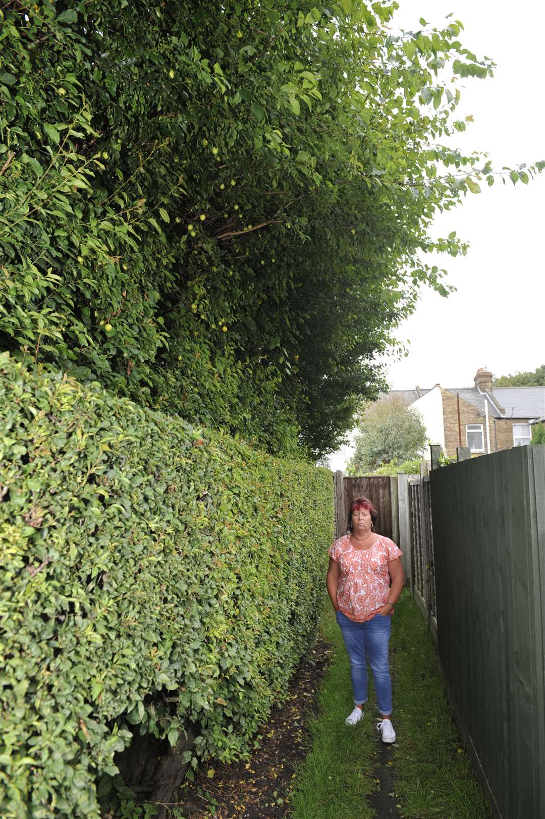 Dawn James next to the hedge